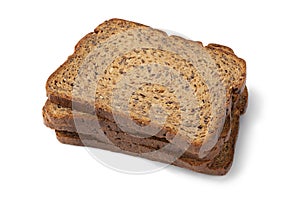 Thin slices of fresh baked brown flaxseed bread close up on white background