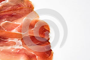 Thin slices of spanish serrano ham isolated on white background