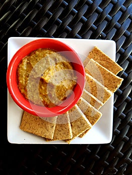 Thyme flavoured almond cracker served with eggplant dip photo
