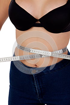 Thin woman with black bra measuring her waist