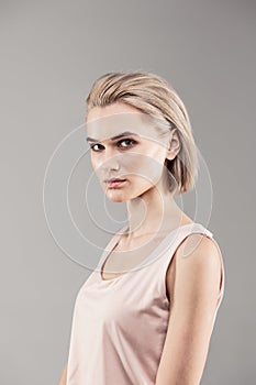 Thin young lady looking serious during photoshoot