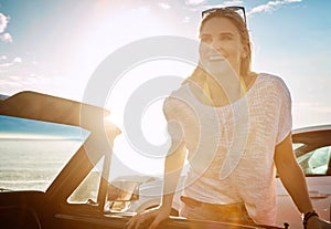 The only thing she packed was a desire for adventure. a happy young woman enjoying a summers road trip.