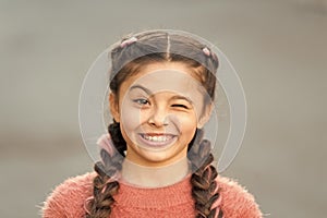 Things gonna be alright. Girl wink cheerful face grey background. Kid girl cheerful satisfied with everything. Cheerful photo