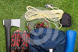 Things for a long hike in the forest and survival in it, set on a green lawn