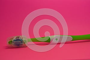 Things, personal hygiene products, new toothbrush placed on pink background.