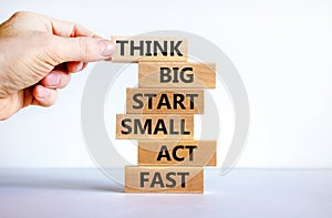 Think big start small symbol. Words `Think big start small act fast` on wooden blocks on a beautiful white background. Businessm