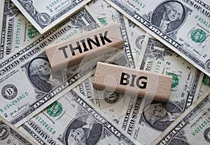 Think big symbol. Wooden blocks with words Think big. Beautiful dollar background. Business and Think big concept. Copy space