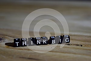 Think big on wooden blocks. Motivation and inspiration concept