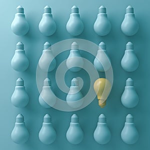 Think different concept , One yellow light bulb stand out from unlit green incandescent lightbulbs with shade and shadow