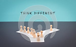 Think different stands on the blue background, one nonconformist is standing out from the crowd, creative and visionary concept photo