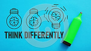 Think differently is shown using the textand pictures of lamps with brains