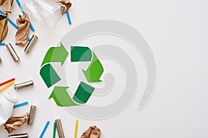 Think about ecology. Crumple paper, plastic and batteries near recycle symbol