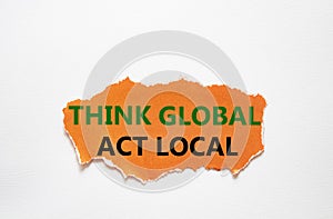 Think global act local symbol. Torn orange paper with words Think global act local. Beautiful white background. Business and Think