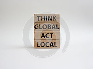 Think global act local symbol. Wooden blocks with words Think global act local . Beautiful white background. Business and Think