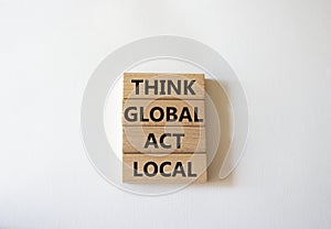 Think global act local symbol. Wooden blocks with words Think global act local. Beautiful white background. Business and Think