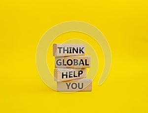 Think global act local symbol. Wooden blocks with words Think global act local . Beautiful yellow background. Business and Think