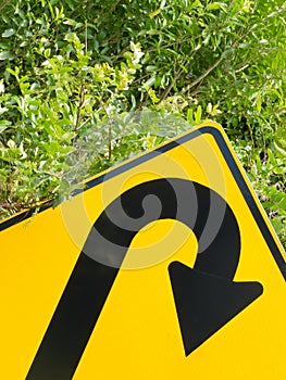 Think green - U-turn roadsign in lush vegetation