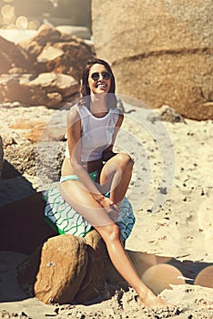 Think a little less and live a little more. an attractive young woman enjoying a day on the beach.