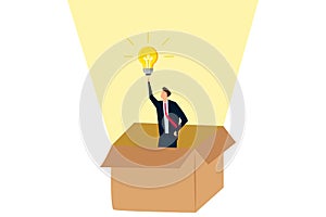 Think outside the box, smart businessman get out of paper box with new illumination lightbulb idea