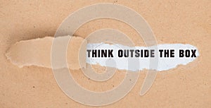 Think outside the box is standing on pieces paper, brainstorming for new ideas, being innovative, business concept