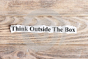 Think Outside The Box text on paper. Word Think Outside The Box on torn paper. Concept Image