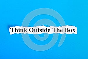 Think Outside The Box text on paper. Word Think Outside The Box on torn paper. Concept Image