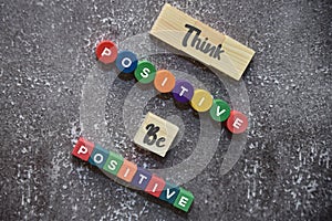 THINK POSITIVE BE POSITIVE wording on the wooden blocks lifestyle concept