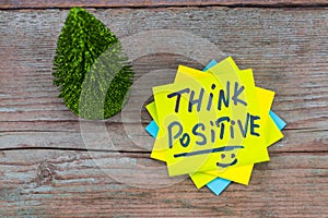 Think positive - inspirational handwriting in a green sticky not