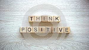 Think positive phrase made of cubes, psychological help to fight insecurities