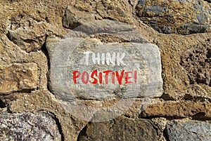 Think positive symbol. Concept words Think positive on beautiful grey stone. Beautiful brown stone wall background. Business,