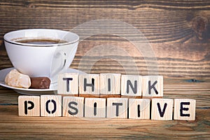 Think positive. Wooden letters on the office desk, informative and communication background