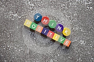 THINK POSITIVE wording on the colorful wooden blocks. Lifestyle concept