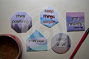 Think Positively concept write on sticky note with keyword isolated on Office Desk