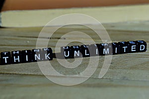 Think unlimited on wooden blocks. Motivation and inspiration concept