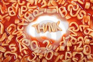 Think written in spaghetti pasta letters surrounded with jumbled letters photo