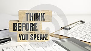 think before you think words on wooden blocks and office supplies