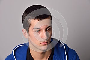 Thinker attractive young man in a blue hoodie