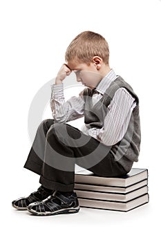 Thinker child sitting on reading books