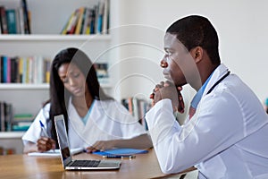 Thinking african american doctor with nurse