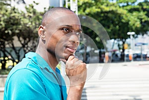 Thinking african american man in bright shirt