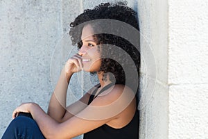 Thinking african american woman with curly black hair