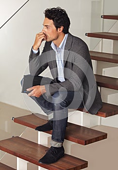 Thinking, anxiety and business man waiting on stairs of office building with stress, fear or worry. Hiring, human