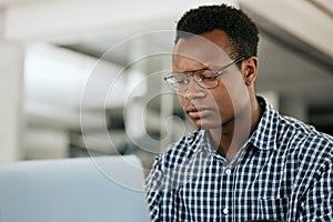 Thinking, black man and laptop for business, online reading and search internet in office. Young male, entrepreneur and