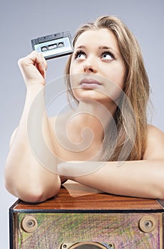 Thinking Blond Female Holding Old Audio Cassette