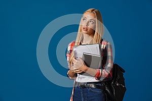 Thinking blonde caucasian girl posing with documents and planner