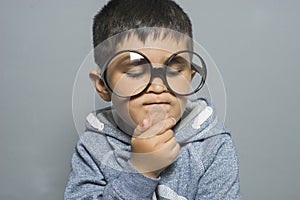 Thinking, boy with big glasses very serious and thinking