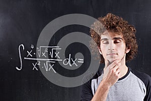 Thinking boy with blackboard solving equation