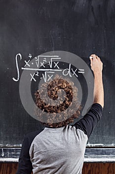 Thinking boy with blackboard solving equation