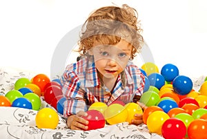 Thinking boy with colorful balls