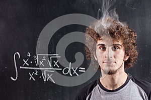 Thinking boy solving equation with smoking head photo